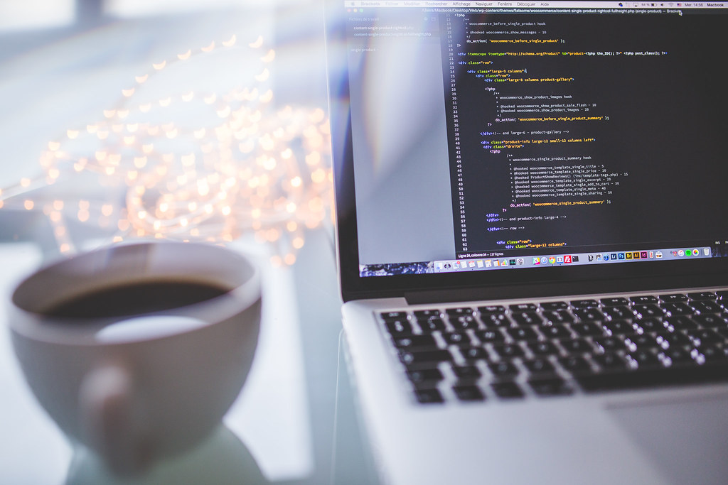 Laptop displaying a programmer's website development workspace